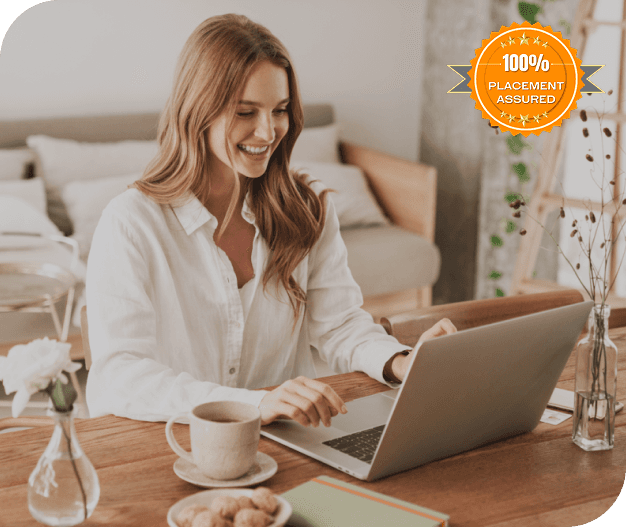 A smiling woman working on her laptop.